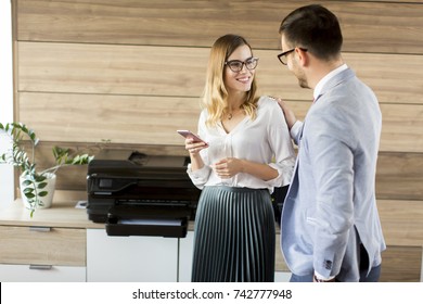 Young Business Couple Talking In Office By The Scanner Mashine