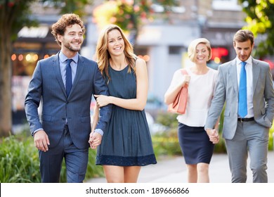 Young Business Couples Walking Through City Park Together