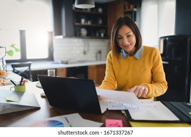 Young business entrepreneur woman working at home while having breakfast - Powered by Shutterstock