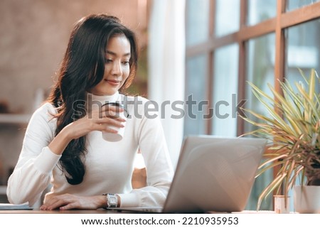young business freelance woman lifestyle with online work communication job in cafes, businesswoman entrepreneur holding hot drink coffee cup by using laptop computer on cyberspace modern technology