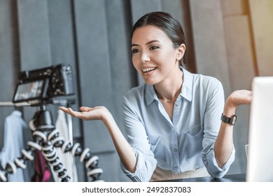 Young business girl blogger filming video on digital camera. Female vlogger recording broadcast webinar at home office coworking. Smiling businesswoman coach teacher looking at camera - Powered by Shutterstock