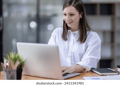 Young business hispanic woman work on laptop desk doing math finance on an office desk, tax, report, accounting, statistics, and analytical research concept