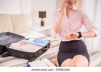Young business lady hurring up to meeting and talking by phone. Close-up.