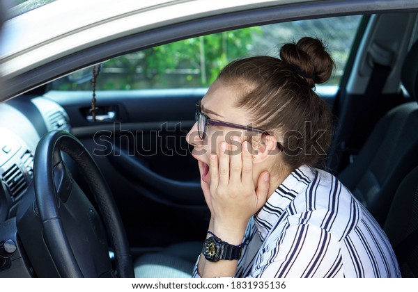 young business lady speaks on phone wearing a\
medical mask inform about car accident. Telephone conversation\
about the tragedy at distance during quarantine period. Negative\
emotions of fear anxiety.