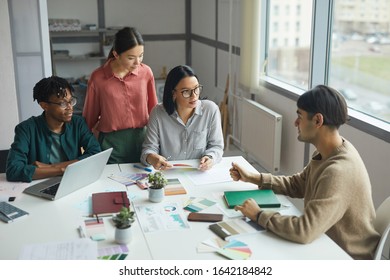 Young business leader talking to his business team and they listening to him attentively during meeting at office - Shutterstock ID 1642184842