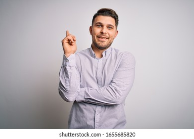 Young Business Man With Blue Eyes Standing Over Isolated Background With A Big Smile On Face, Pointing With Hand And Finger To The Side Looking At The Camera.