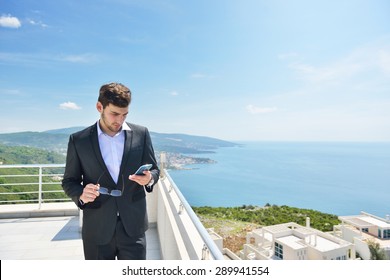 Young Business Man Calling By Cell Phone On White Beach