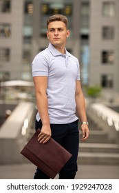 Young  Business Man In Classic Look Walking On The Street With Briefcase Designer Leather Laptop Satchel Portfolio Messenger Bag.  Different Color Of Bag And No Logo.