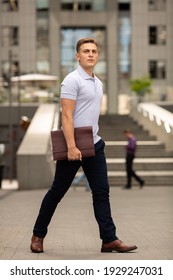 Young  Business Man In Classic Look Walking On The Street With Briefcase Designer Leather Laptop Satchel Portfolio Messenger Bag.  Different Color Of Bag And No Logo.