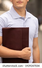 Young  Business Man In Classic Look Walking On The Street With Briefcase Designer Leather Laptop Satchel Portfolio Messenger Bag.  Different Color Of Bag And No Logo.