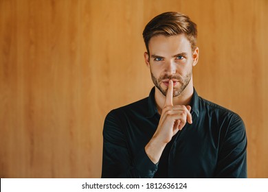 Young Business Man In Classic Shirt Isolated On Wooden Background. Quiet With Finger On Lips Shhh Gesture