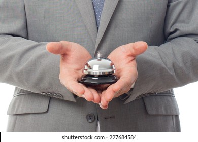 Young Business Man Close Up Over White Background. Holding A Hotel Bell