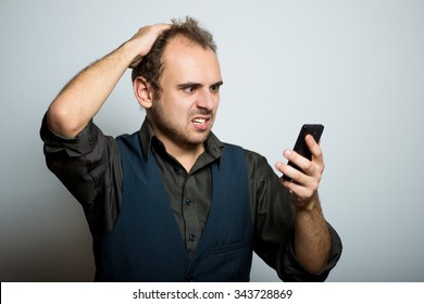 Young Business Man Disappointed On The Phone, Manager, Office Style Studio Shot Isolated On The Gray Background