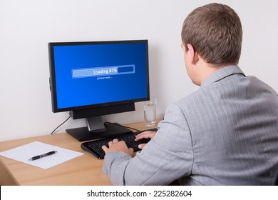 young business man downloading something from internet using personal computer in office