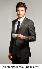 Young Business Man Drinking A Cup Of Coffee Or Tea