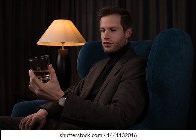 Young business man is drinking whiskey at a hotel bar  - Powered by Shutterstock