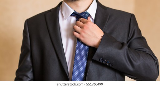 Young Business Man Fixing his Tie, wedding tie