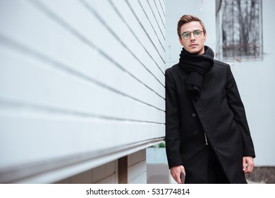 Young Business Man In Glasses And Warm Clothes Near The House