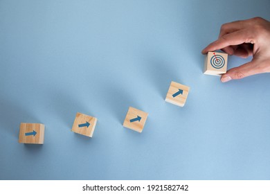 young business man holding cubes and target - Shutterstock ID 1921582742