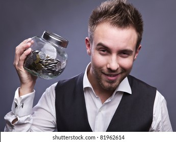 Young Business Man Holding Jar With Coins  - Retirement Fund And Savings Concept