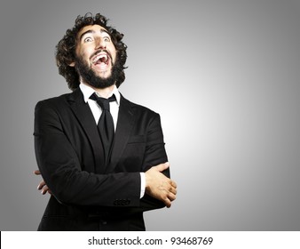 Young Business Man Laughing Over Grey Background