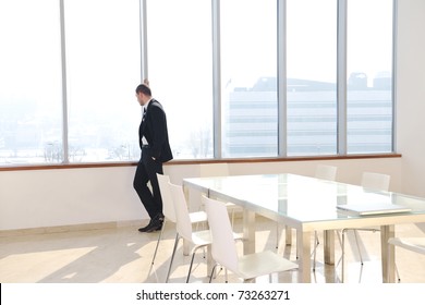 young business man lawyer with laptop alone in big bright   conference room - Powered by Shutterstock