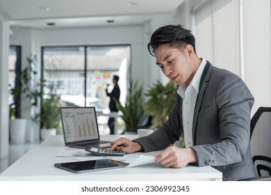 young business man look at laptop screen calculate expenses expenditures pay bills taxes online. male busy managing company budget, take care of financial paperwork
