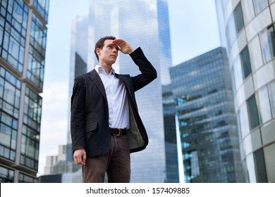 Young Business Man Looking Forward On Skyscrapers Background