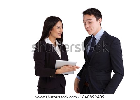 A young business man is looking at a tablet. A smiling young business woman is holding a tablet.