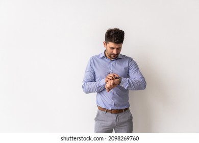 Young Business Man Looking At Watch Over White Background