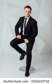 Young Business Man In Modern Suit Sitting On Chair