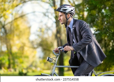 Young Business Man On A Bike Hurry To Work