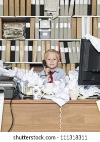 Young Business Man On The Phone In A Messy Office