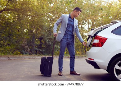 Young Business Man Opens Car Trunk