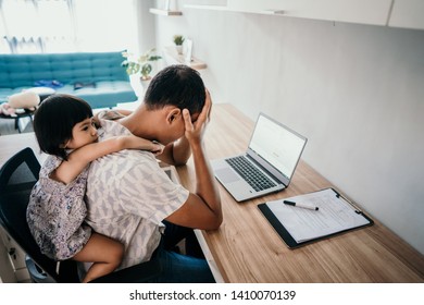 Young Business Man Parent Interrupts By Her Daughter While Working In The Office