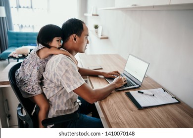 Young Business Man Parent Interrupts By Her Daughter While Working In The Office