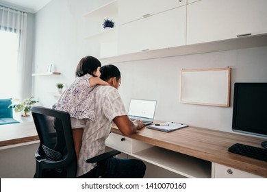 young business man parent interrupts by her daughter while working in the office