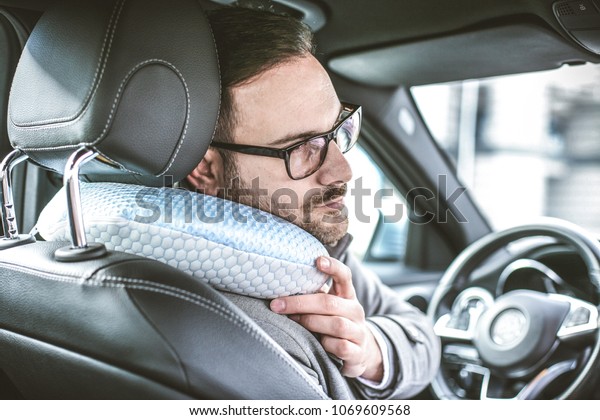 Young business man resting\
in car.