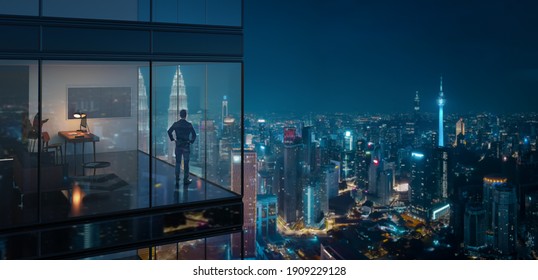 Young business man standing in the 3d rendering office watching the modern city night view, view from the outside. Business ambition concept.