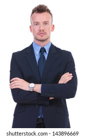 Young Business Man Standing With His Hands Folded While Looking At The Camera With A Serious Expression. On White Background