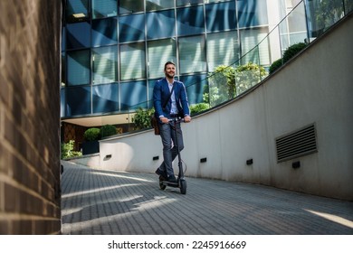 Young business man in a suit riding an electric scooter on a business meeting. Ecological transportation concept - Powered by Shutterstock