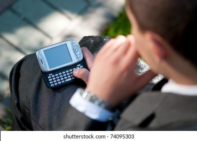 Young Business Man Talking By Mobile Cell Phone, At Green Park. Student.