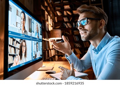 Young Business Man Talking With Diverse Colleagues In Virtual Video Conference Group Chat Using Computer At Home Office. Online Professional Videoconference Communication, Social Distance Work Concept