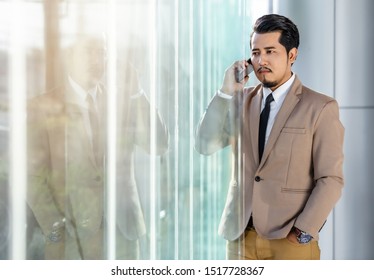 Young Business Man Talking With Mobile Phone In Office