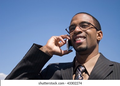 A Young Business Man Talking On His Cell Phone Where He Has Service.