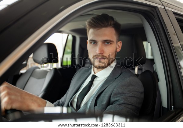 Young business man test\
drive new car
