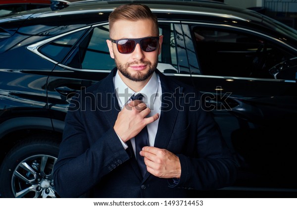 Young business man test\
drive new car.