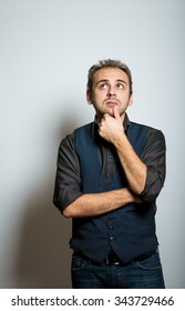 a young business man thinking, office style clothes, studio shot isolated on the gray background