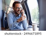 Young business man traveling to work by train, working while traveling, talking on phone. Young business man traveling to work by train. 