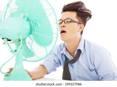 Young Business Man Use Fans To Cool Down